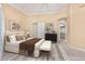 Serene bedroom features neutral tones, a king bed with a bench, and ensuite bathroom at 7538 E Tuckey Ln, Scottsdale, AZ 85250