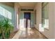 Inviting front entryway featuring travertine flooring and shuttered sidelight windows at 7538 E Tuckey Ln, Scottsdale, AZ 85250
