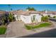 Aerial view of home with mature landscaping, a paver driveway and walkway, and a tile roof at 7538 E Tuckey Ln, Scottsdale, AZ 85250
