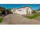 Inviting single-story home featuring desert landscaping, a tile roof, and an attached garage at 7538 E Tuckey Ln, Scottsdale, AZ 85250