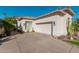 Home featuring a garage and desert landscaping at 7538 E Tuckey Ln, Scottsdale, AZ 85250