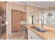 Kitchen featuring an island with a sink and custom wood cabinetry at 7538 E Tuckey Ln, Scottsdale, AZ 85250