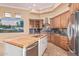 Gourmet kitchen featuring granite countertops, stainless appliances, and a center island at 7538 E Tuckey Ln, Scottsdale, AZ 85250
