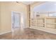 A living room with stone floors, built-in shelving, and an open doorway, ready for your touch! at 7538 E Tuckey Ln, Scottsdale, AZ 85250