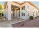 Outdoor patio featuring travertine tile, a ceiling fan, large windows and door, and desert landscaping at 7538 E Tuckey Ln, Scottsdale, AZ 85250