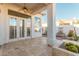 Covered patio with ceiling fan, travertine flooring, and view of private yard with fountain at 7538 E Tuckey Ln, Scottsdale, AZ 85250