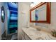 Cozy bathroom with classic vanity, tiled floors and walk-in shower behind striped curtain at 811 E Seldon Ln, Phoenix, AZ 85020