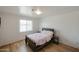 Comfortable bedroom features wood-look flooring and a bright window for natural light at 811 E Seldon Ln, Phoenix, AZ 85020