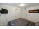 Relaxing bedroom with a built-in closet and a wall-mounted television at 811 E Seldon Ln, Phoenix, AZ 85020