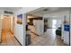 Hallway with access to the kitchen, dining area, and bedrooms, complemented by tile flooring at 811 E Seldon Ln, Phoenix, AZ 85020