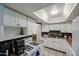 Well-lit kitchen with white cabinets, neutral countertops and backsplash at 811 E Seldon Ln, Phoenix, AZ 85020