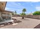 Low maintenance backyard with decorative stone and shaded patio area at 8315 E Lobo Ave, Mesa, AZ 85209