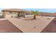 Low maintenance backyard with decorative stone and shaded patio area at 8315 E Lobo Ave, Mesa, AZ 85209