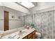 The bathroom features a single sink vanity with an extended countertop and tub-shower combination at 8315 E Lobo Ave, Mesa, AZ 85209