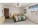 View of the bedroom showing a ceiling fan and a large window for natural light at 8315 E Lobo Ave, Mesa, AZ 85209