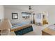 Bright bedroom featuring a ceiling fan, neutral carpet, and a view to the en-suite bathroom at 8315 E Lobo Ave, Mesa, AZ 85209