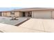 Wide view of the home from the street, showing its two-car garage and low-maintenance desert landscaping at 8315 E Lobo Ave, Mesa, AZ 85209
