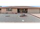 Charming single-story home featuring desert landscaping, a covered porch, and attached two-car garage at 8315 E Lobo Ave, Mesa, AZ 85209