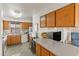 Bright kitchen featuring tile floors, plentiful cabinets, and modern appliances at 8315 E Lobo Ave, Mesa, AZ 85209