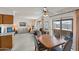 Spacious living room with large windows, neutral tones, and adjacent dining area at 8315 E Lobo Ave, Mesa, AZ 85209