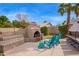 Backyard featuring stucco fireplace, built-in seating, and bright blue patio chairs at 851 N Citrus Cove --, Mesa, AZ 85213