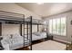 Bedroom with bunk beds, shuttered window, and patterned bedding at 851 N Citrus Cove --, Mesa, AZ 85213
