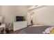 Well-lit bedroom featuring a dresser, television, and convenient access to another room at 851 N Citrus Cove --, Mesa, AZ 85213