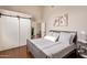 Inviting bedroom features neutral tones, hardwood floors, and sliding barn door at 851 N Citrus Cove --, Mesa, AZ 85213