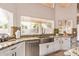Bright kitchen with stainless steel appliances, granite countertops, a large window, and a farmhouse sink at 851 N Citrus Cove --, Mesa, AZ 85213