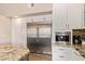 Chef's kitchen with a large stainless steel refrigerator and built-in coffee system at 851 N Citrus Cove --, Mesa, AZ 85213