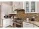 Gourmet kitchen featuring professional-grade appliances, granite countertops, and custom tile backsplash at 851 N Citrus Cove --, Mesa, AZ 85213