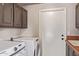 Practical laundry area featuring modern washer and dryer with tile countertops at 851 N Citrus Cove --, Mesa, AZ 85213