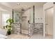 A luxurious main bathroom with a glass-enclosed shower, neutral tile accents, and modern fixtures at 851 N Citrus Cove --, Mesa, AZ 85213