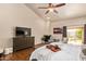 Spacious bedroom with a fireplace, ceiling fan, and sliding door access to the outdoor area at 851 N Citrus Cove --, Mesa, AZ 85213
