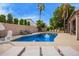 Sparkling pool area with lounge chairs, patio seating, and lush greenery at 851 N Citrus Cove --, Mesa, AZ 85213