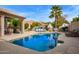 Sparkling pool with a lounging area, pizza oven, and lush tropical landscaping, perfect for outdoor entertaining at 851 N Citrus Cove --, Mesa, AZ 85213