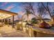 Outdoor kitchen with a built-in grill, sink, and dining area surrounded by beautiful landscaping at 911 E Desert Inn Dr, Chandler, AZ 85249