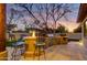 Backyard kitchen with a fire pit, outdoor seating, and mature trees at 911 E Desert Inn Dr, Chandler, AZ 85249