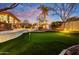 Backyard with a putting green, lush landscaping, and an outdoor entertainment area at 911 E Desert Inn Dr, Chandler, AZ 85249