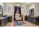 Elegant bathroom with a clawfoot tub, dual sinks, decorative mirrors and stylish accents at 911 E Desert Inn Dr, Chandler, AZ 85249