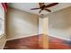 A bedroom features hardwood floors, ceiling fan, neutral walls, and bright natural light at 911 E Desert Inn Dr, Chandler, AZ 85249