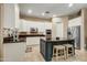 Spacious kitchen with a dark island, stainless appliances, and white cabinets for a modern feel at 911 E Desert Inn Dr, Chandler, AZ 85249