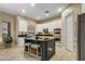 Well-lit kitchen with white cabinets, mosaic backsplash, dark island, and stainless steel appliances at 911 E Desert Inn Dr, Chandler, AZ 85249