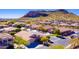 Scenic aerial view showcasing a desert community nestled near a picturesque mountain range at 9733 W Hedge Hog Pl, Peoria, AZ 85383