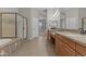 Bathroom with granite countertops, dual sinks, a walk-in shower, and a separate bathtub at 9733 W Hedge Hog Pl, Peoria, AZ 85383