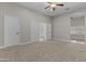 Spacious bedroom with neutral carpet and an arched doorway to another room at 9733 W Hedge Hog Pl, Peoria, AZ 85383
