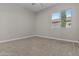 Cozy bedroom featuring neutral paint, carpet, and a bright window at 9733 W Hedge Hog Pl, Peoria, AZ 85383