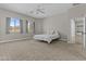 Large bedroom with neutral-toned carpet, offering ample space and natural light from multiple windows at 9733 W Hedge Hog Pl, Peoria, AZ 85383