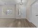 Bright entryway featuring stylish flooring, a modern light fixture, and natural light from the window at 9733 W Hedge Hog Pl, Peoria, AZ 85383