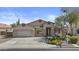 Beautiful home showcasing a well-maintained front yard and attached two-car garage at 9733 W Hedge Hog Pl, Peoria, AZ 85383